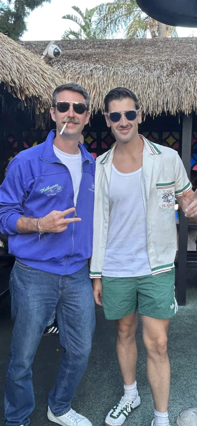 Matt and Andy outside a bar, sunglasses and vintage jackets